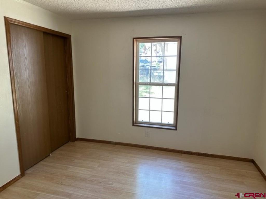 32 Hidden Lane Durango, CO 81303 - Photo 25 of 26 an empty room with wooden floor and windows