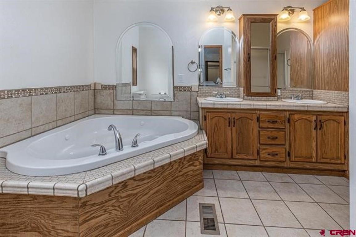 32 Hidden Lane Durango, CO 81303 - Photo 10 of 26 a bathroom with a bathtub and a sink