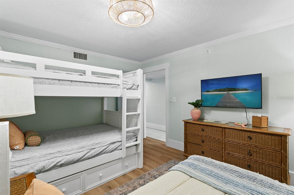 16332 Gulf Boulevard, Unit 3B Redington Beach, FL 33708 - Photo 41 of 91 a living room with furniture and a flat screen tv