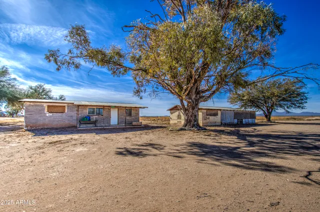 a view of a livingroom with wooden floor and chandelier