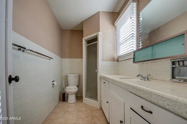 a kitchen with granite countertop cabinets stainless steel appliances a sink and a window