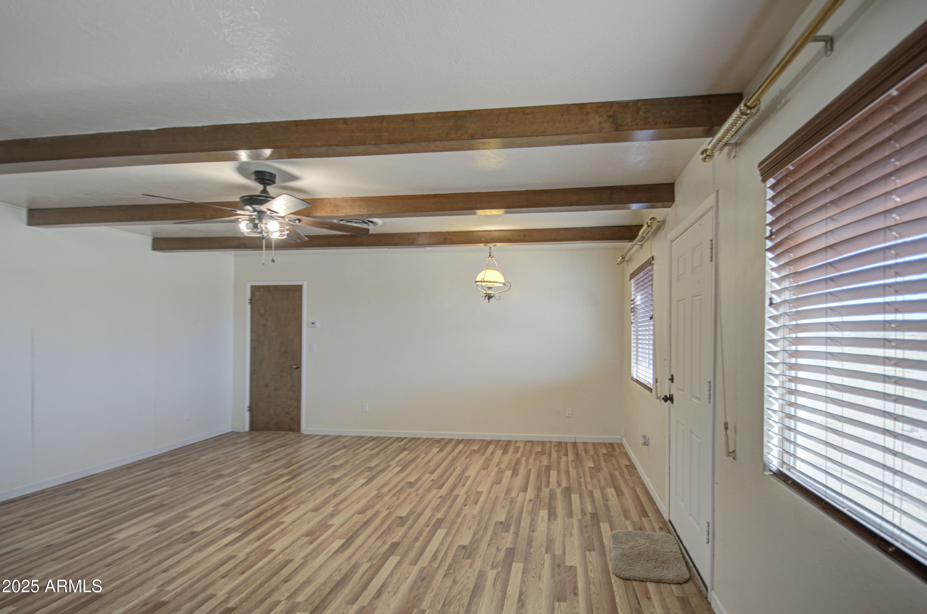 8050 South Bianco Road Casa Grande, AZ 85193 - Photo 26 of 96 a view of a livingroom with wooden floor and chandelier