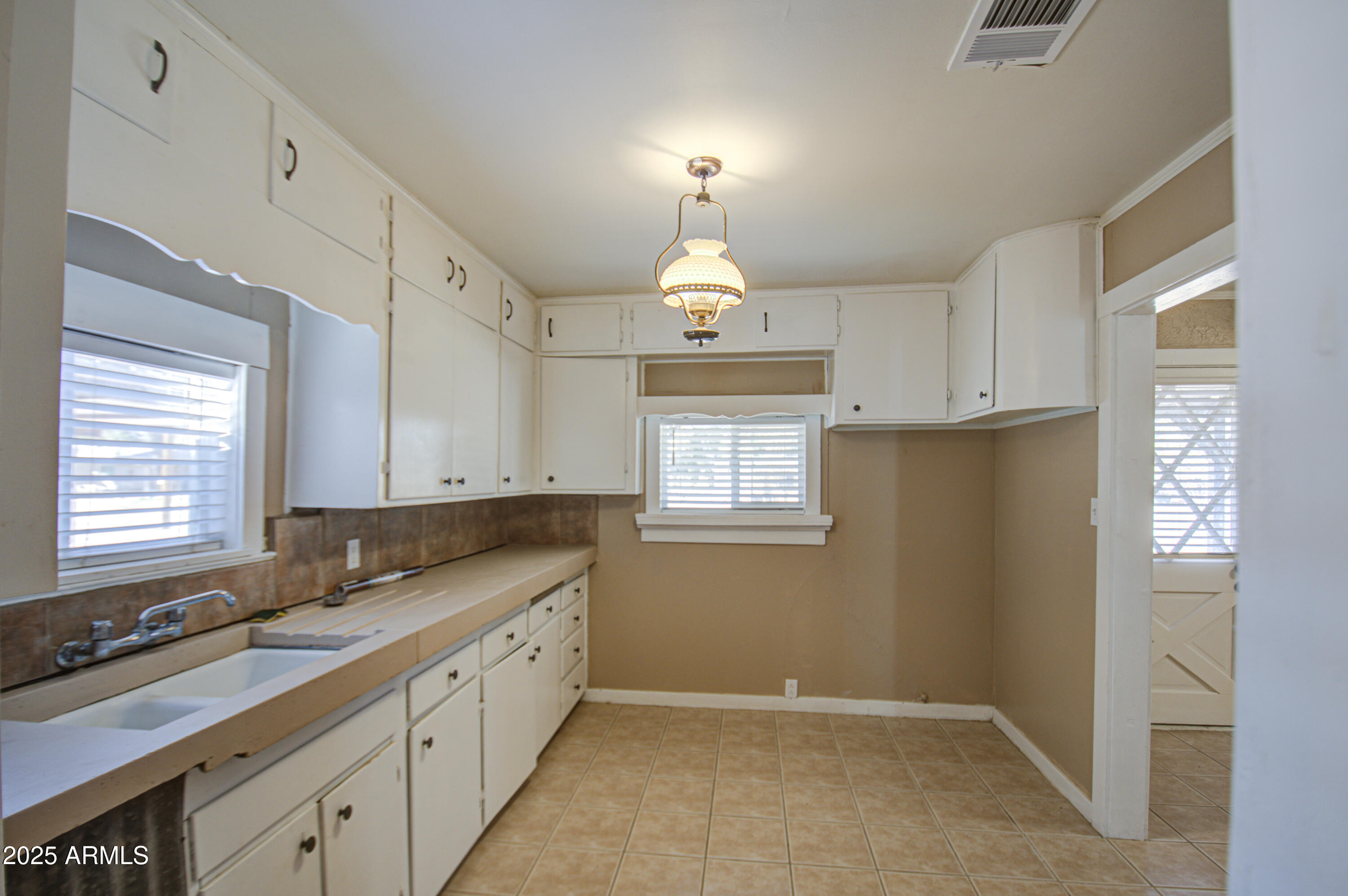8050 South Bianco Road Casa Grande, AZ 85193 - Photo 36 of 96 a kitchen with granite countertop cabinets stainless steel appliances a sink and a window