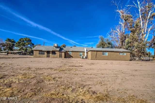 a bathroom with a granite countertop toilet and a sink