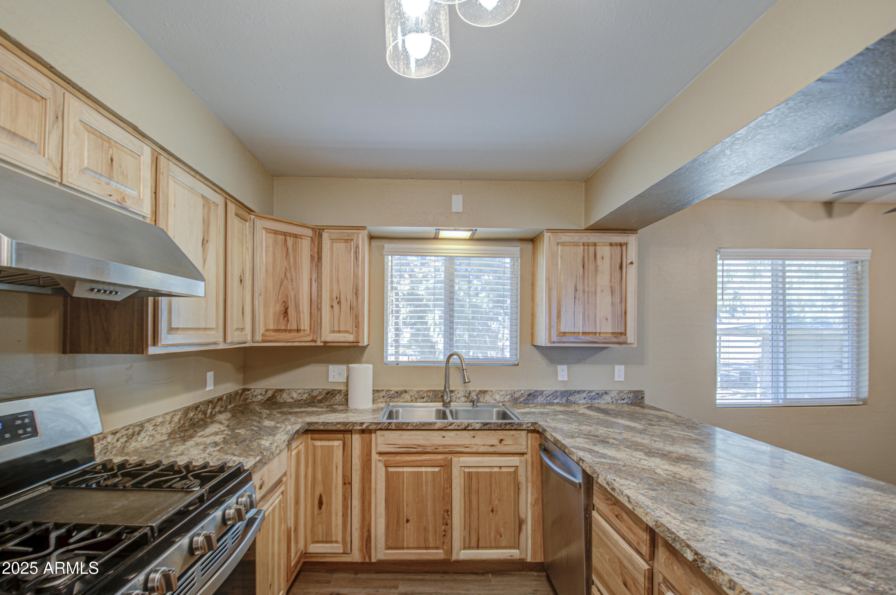 8050 South Bianco Road Casa Grande, AZ 85193 - Photo 67 of 96 a kitchen with stainless steel appliances granite countertop a sink stove and cabinets