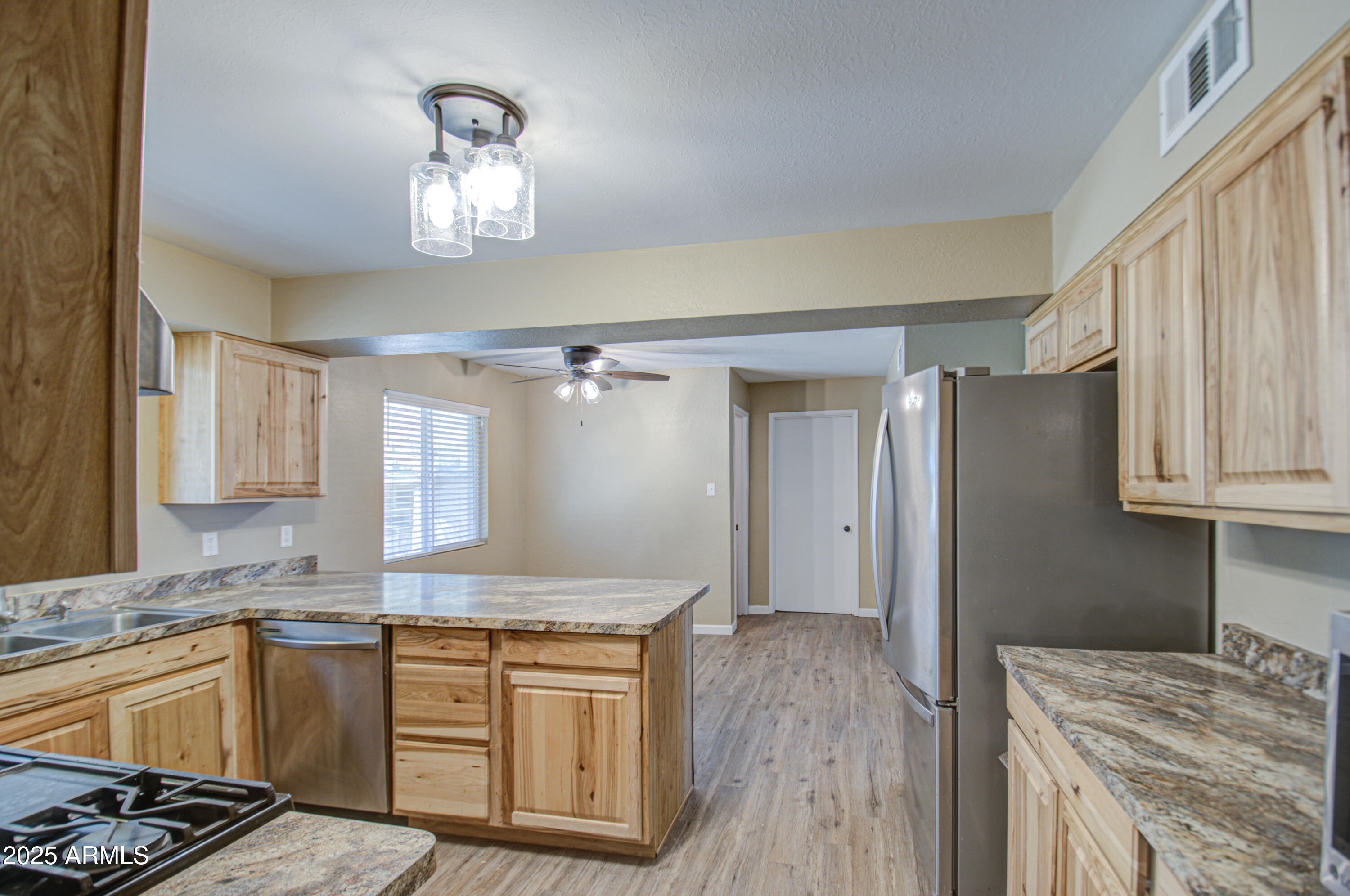 8050 South Bianco Road Casa Grande, AZ 85193 - Photo 68 of 96 a kitchen with granite countertop a sink cabinets and wooden floor