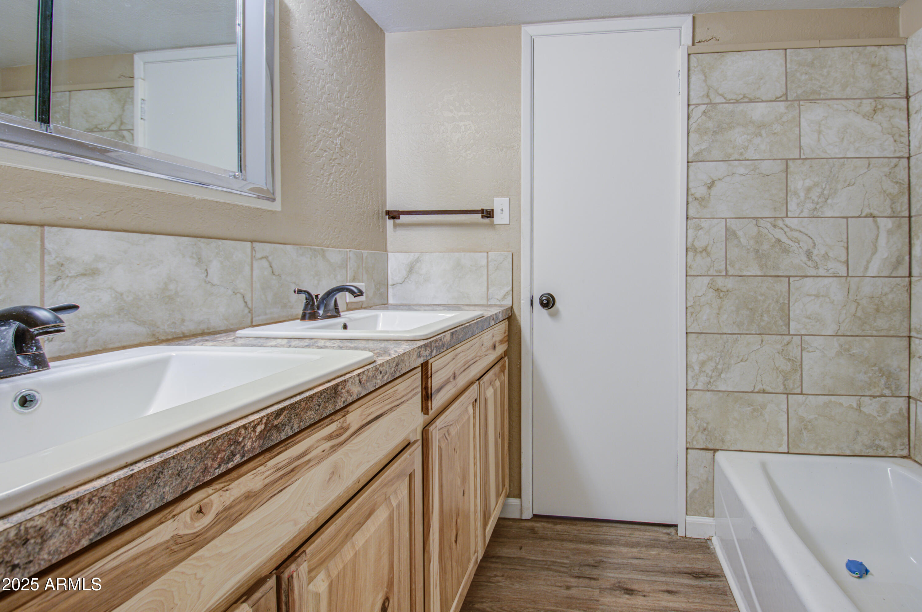 8050 South Bianco Road Casa Grande, AZ 85193 - Photo 70 of 96 a bathroom with a granite countertop sink and a bathtub
