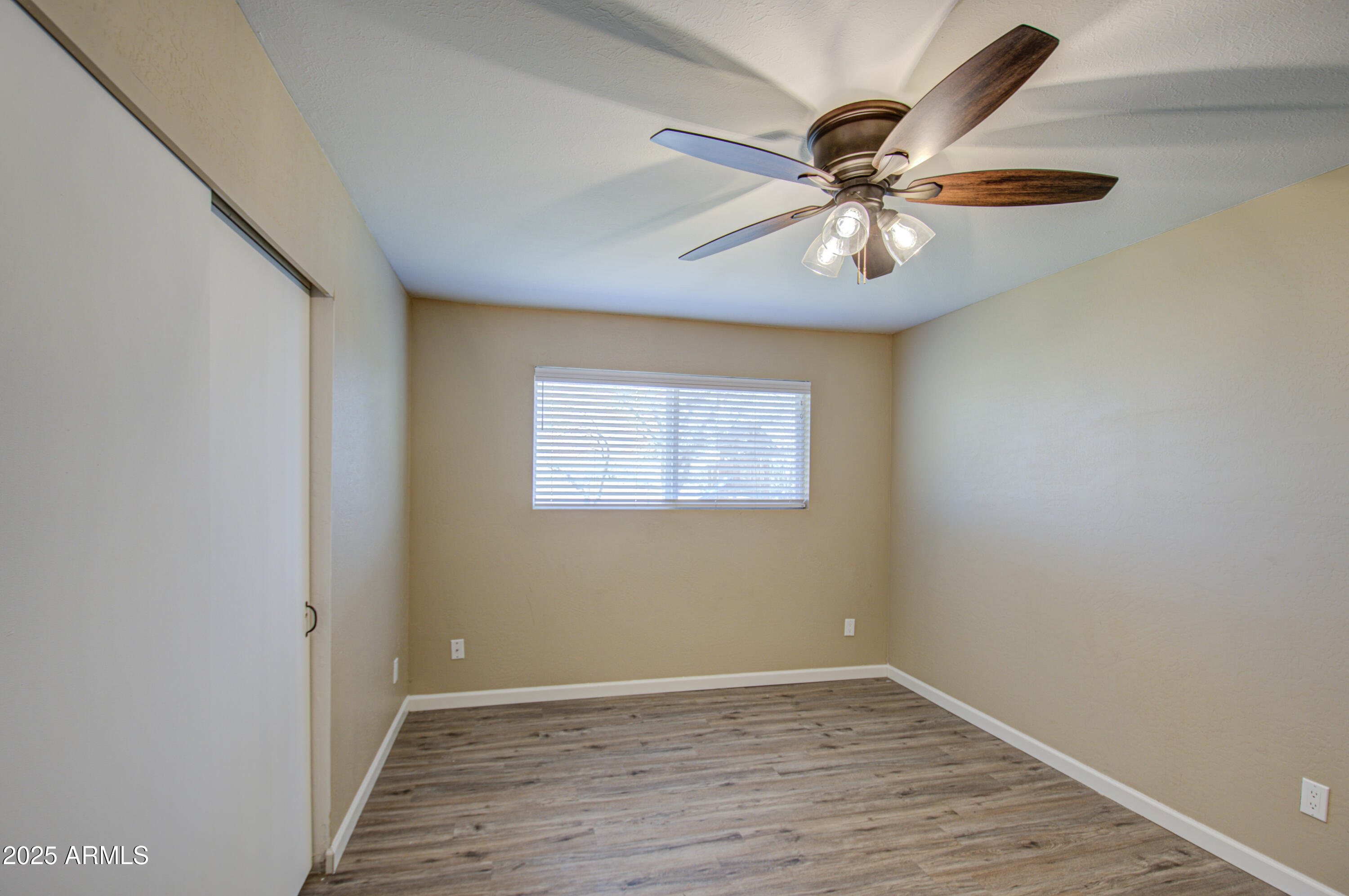 8050 South Bianco Road Casa Grande, AZ 85193 - Photo 73 of 96 wooden floor in an empty room with a window