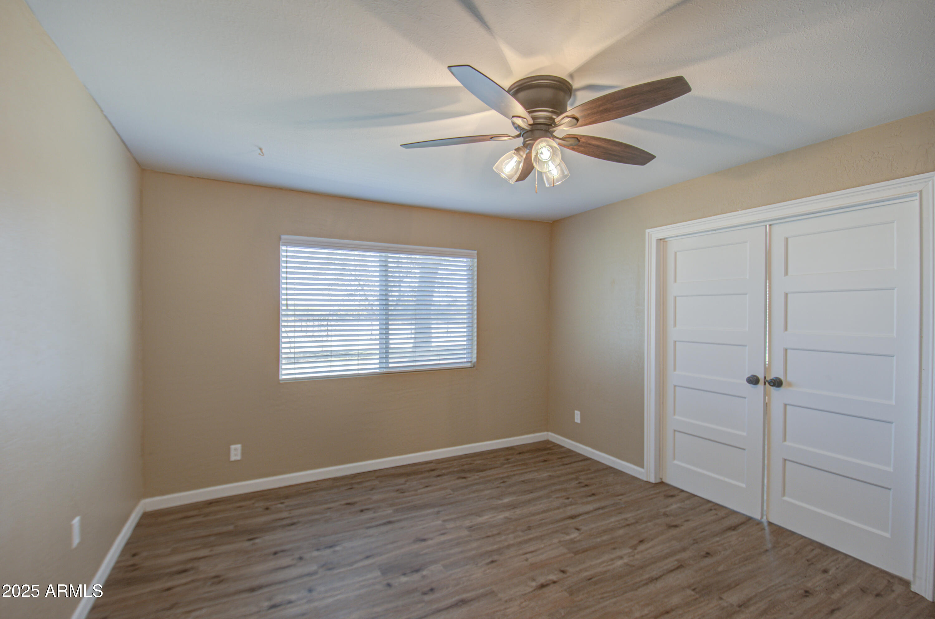 8050 South Bianco Road Casa Grande, AZ 85193 - Photo 75 of 96 a view of an empty room with wooden floor and a window