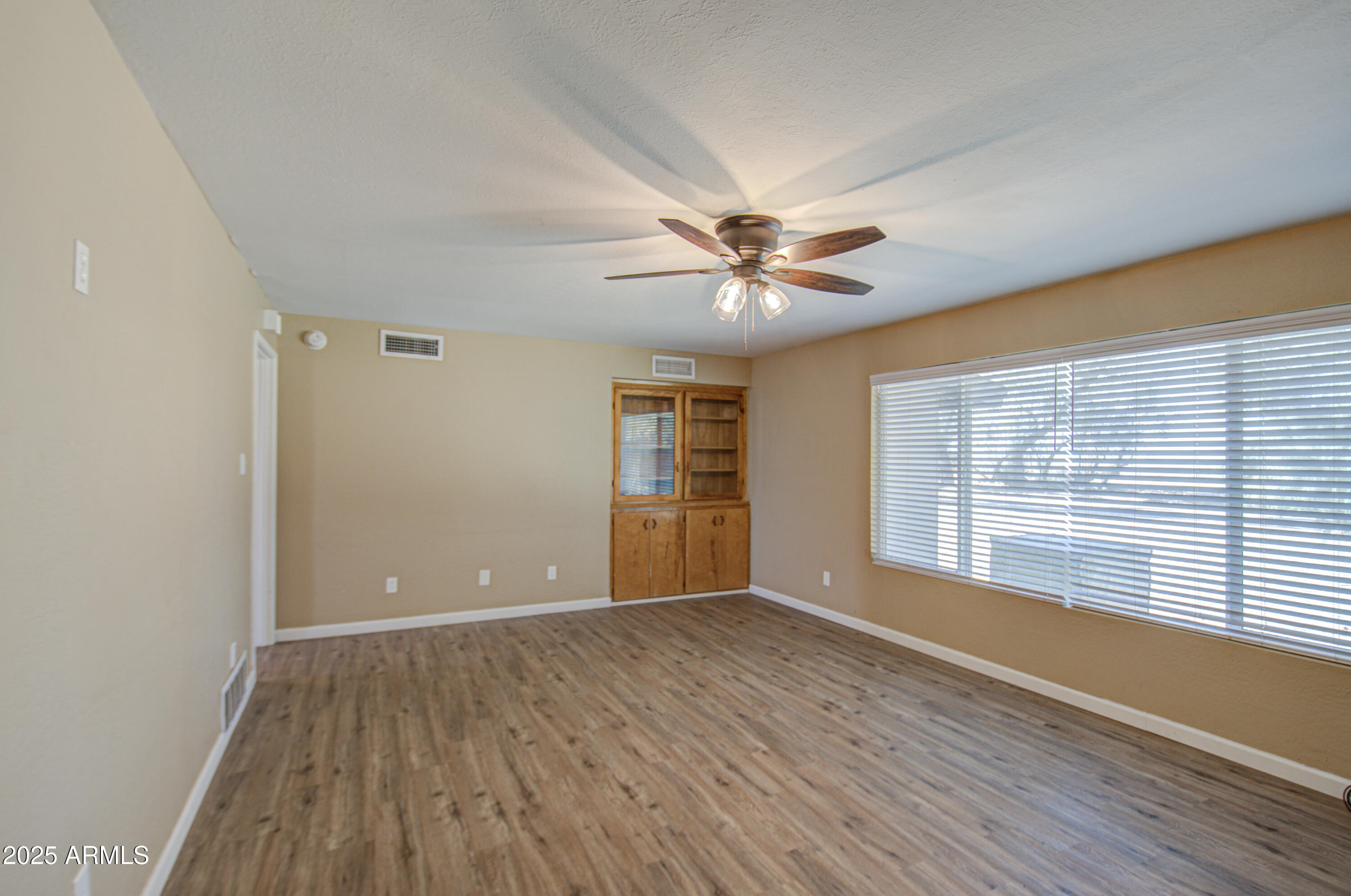 8050 South Bianco Road Casa Grande, AZ 85193 - Photo 79 of 96 a view of an empty room with a window and wooden floor
