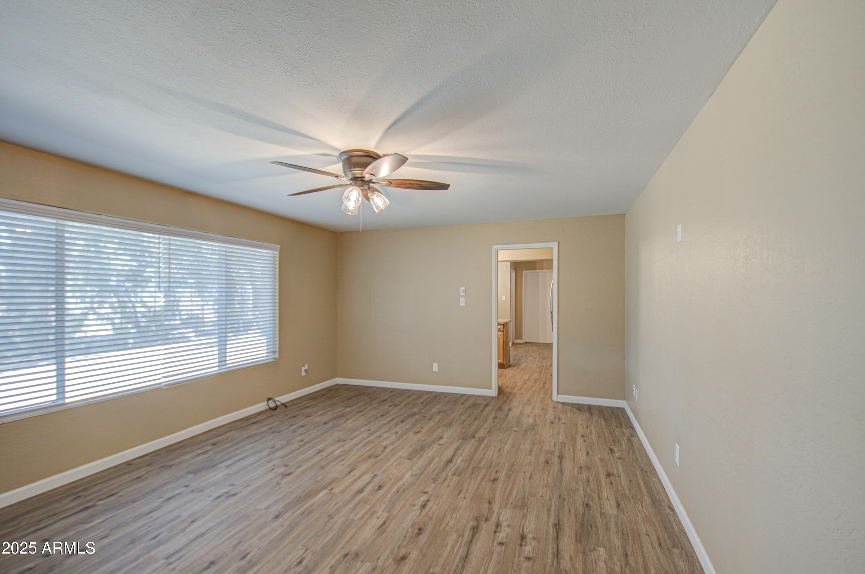 8050 South Bianco Road Casa Grande, AZ 85193 - Photo 82 of 96 a view of an empty room with wooden floor and a window