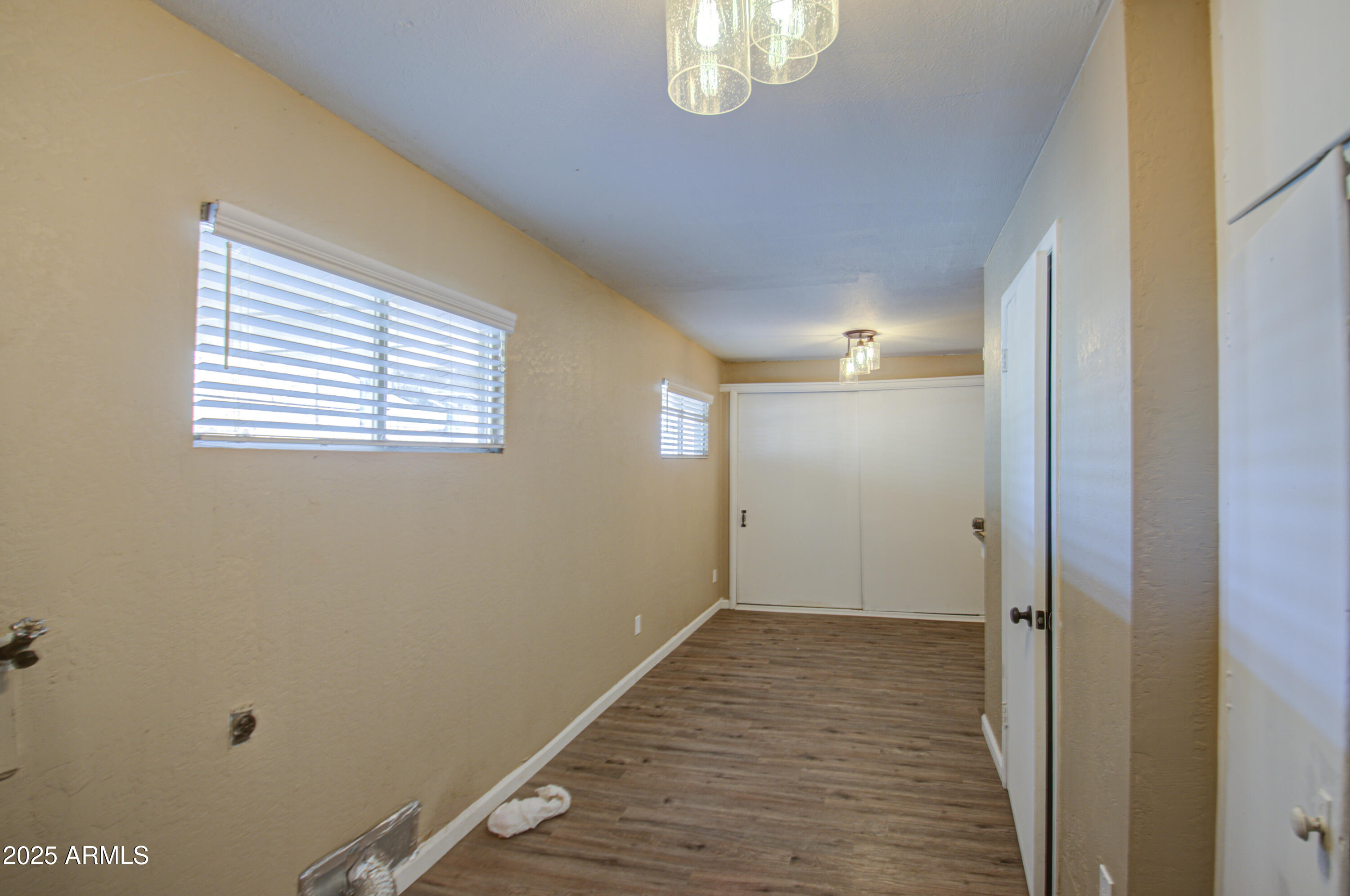 8050 South Bianco Road Casa Grande, AZ 85193 - Photo 84 of 96 a view of an empty room with wooden floor and a window