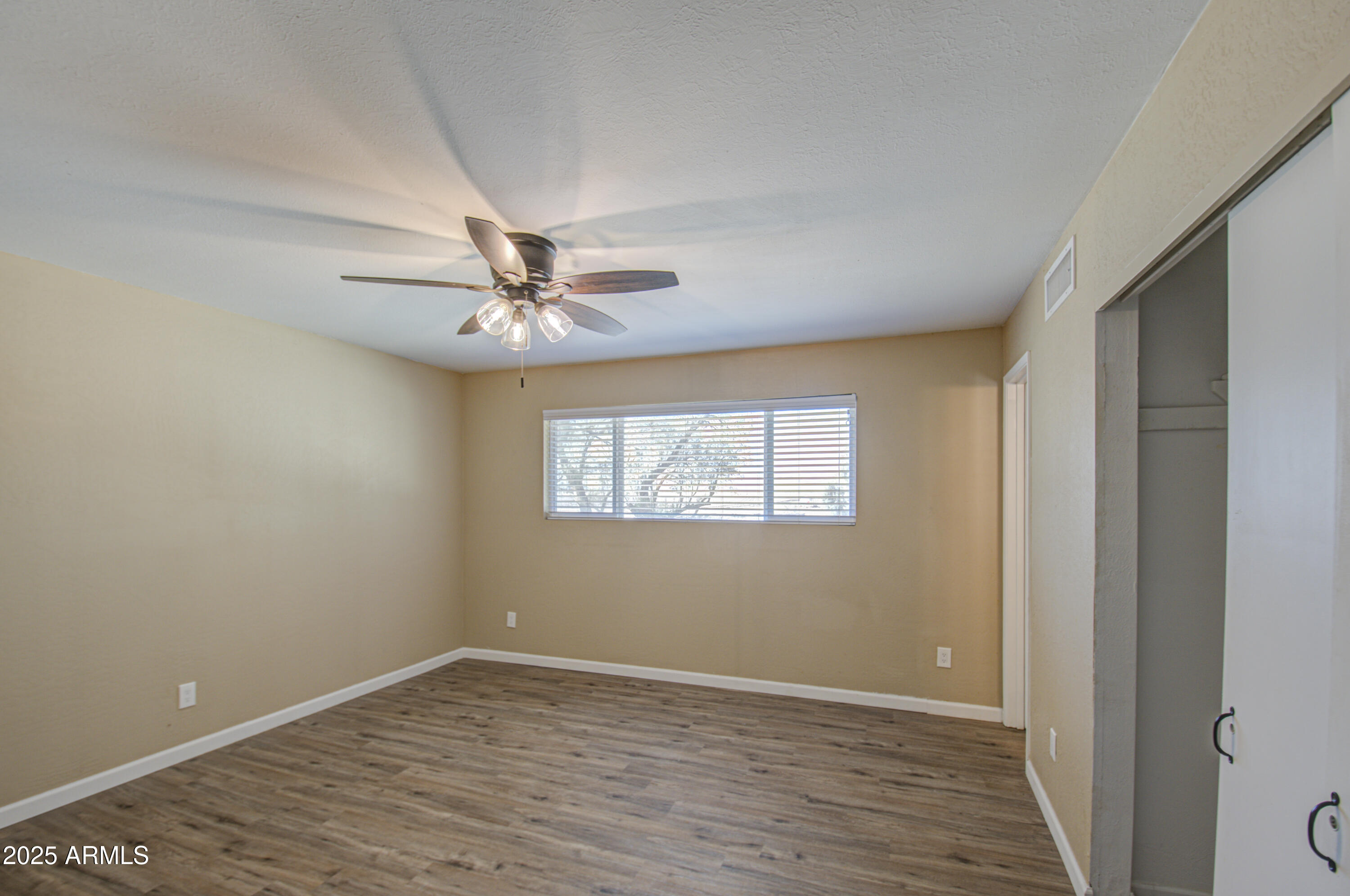 8050 South Bianco Road Casa Grande, AZ 85193 - Photo 91 of 96 wooden floor in an empty room with a window