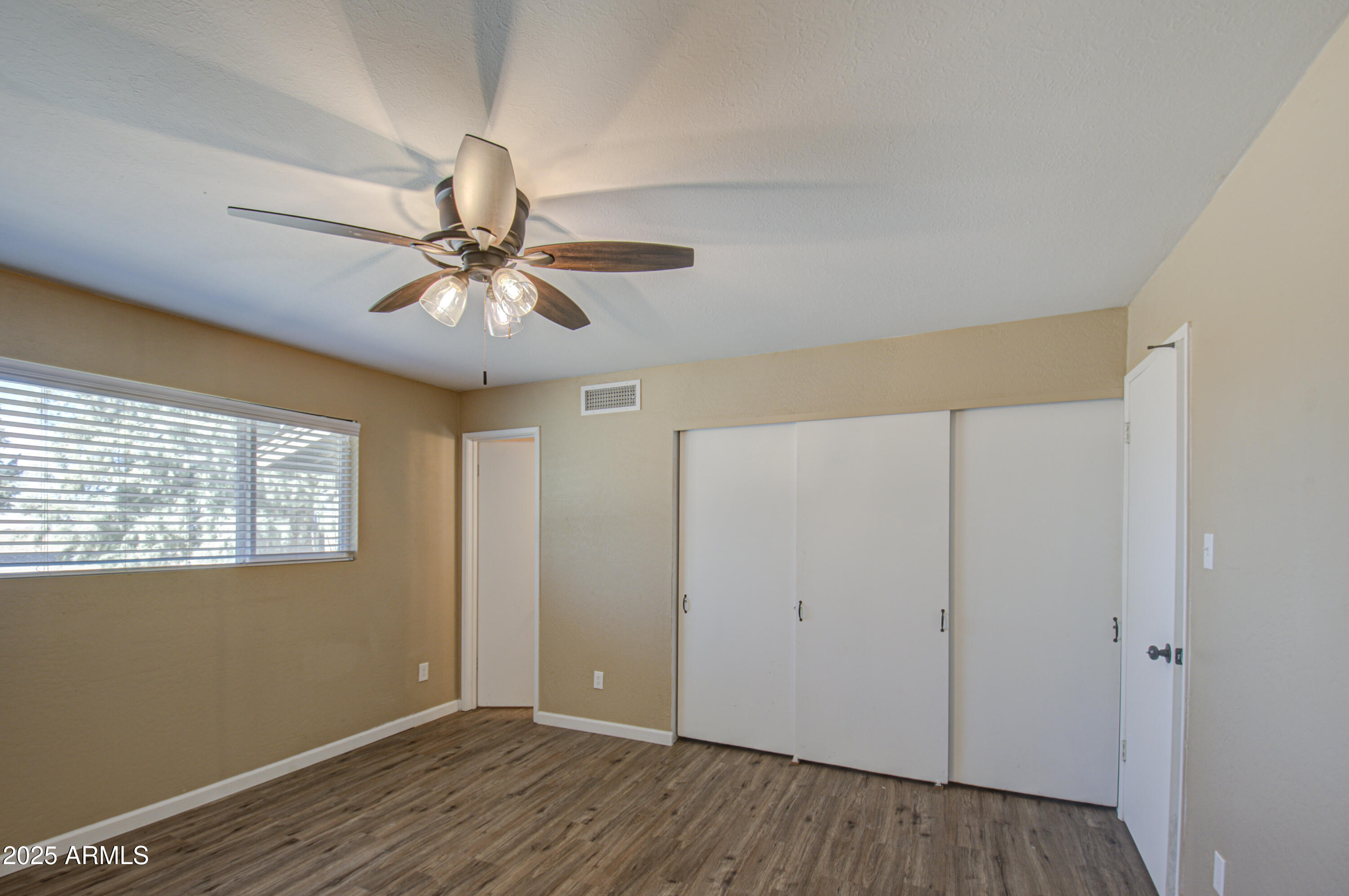 8050 South Bianco Road Casa Grande, AZ 85193 - Photo 92 of 96 a view of an empty room with window and wooden floor
