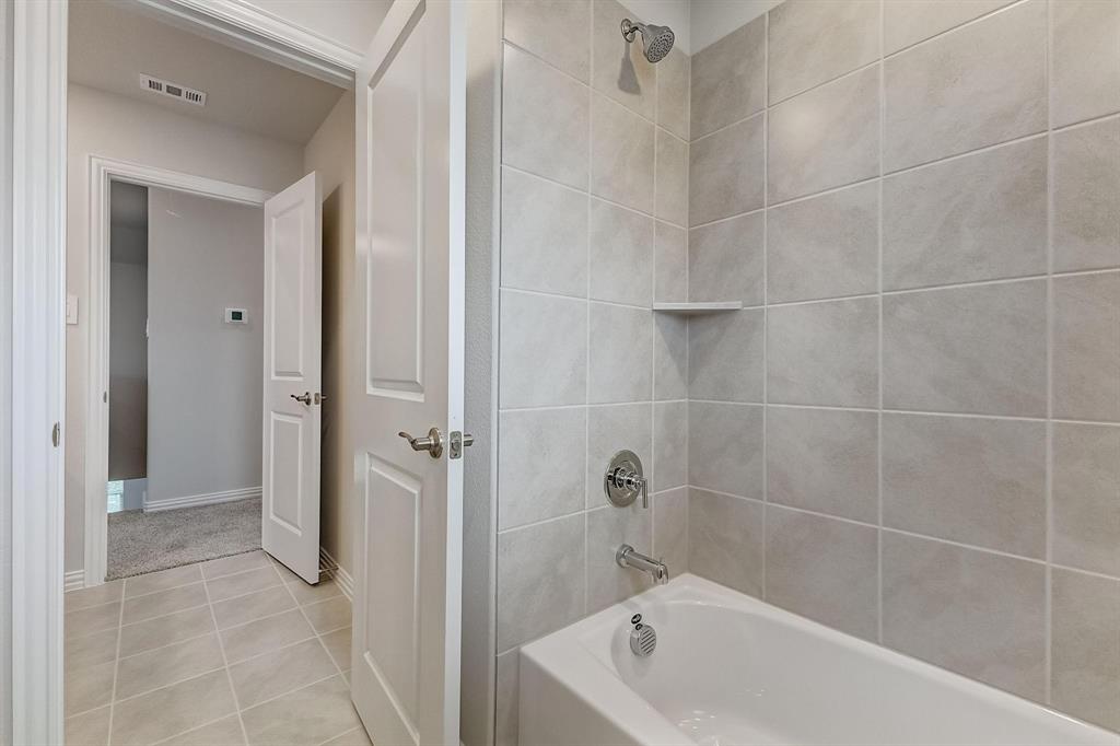 1405 Winters Way McKinney, TX 75071 - Photo 18 of 32 Bathroom with tile patterned flooring and tiled shower / bath combo