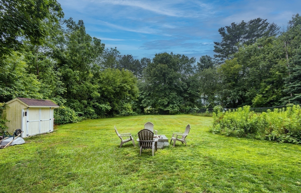 17 Pine Street Bellingham, MA 02019 - Photo 21 of 26 a view of a backyard with grass and a barn