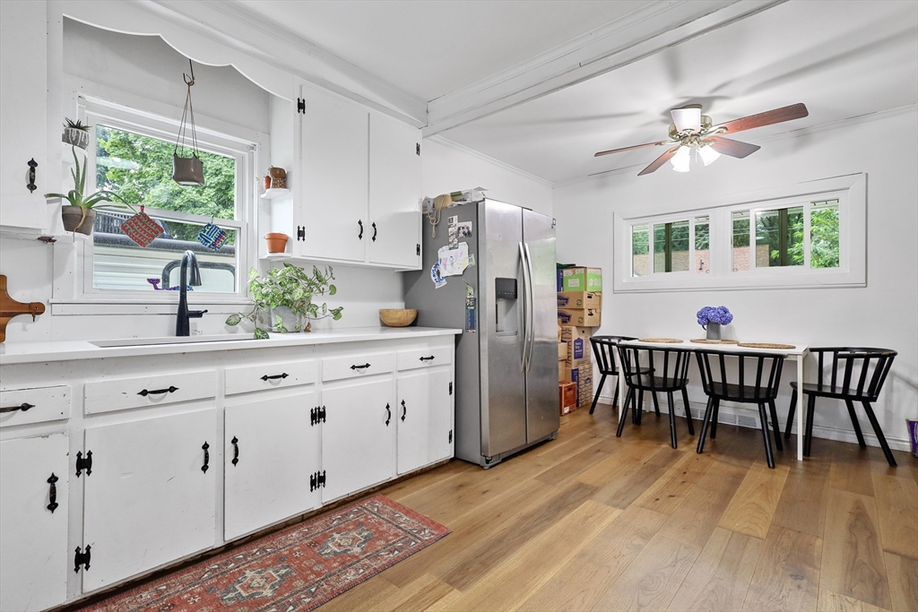17 Pine Street Bellingham, MA 02019 - Photo 3 of 26 a open kitchen with stainless steel appliances granite countertop a stove a sink dishwasher and white cabinets with wooden floor