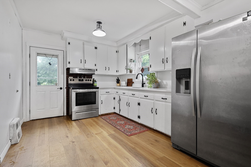 17 Pine Street Bellingham, MA 02019 - Photo 4 of 26 a kitchen with stainless steel appliances a refrigerator sink and stove