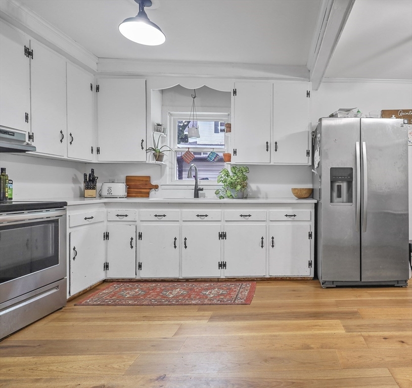 17 Pine Street Bellingham, MA 02019 - Photo 5 of 26 a kitchen with stainless steel appliances a stove refrigerator sink and cabinets