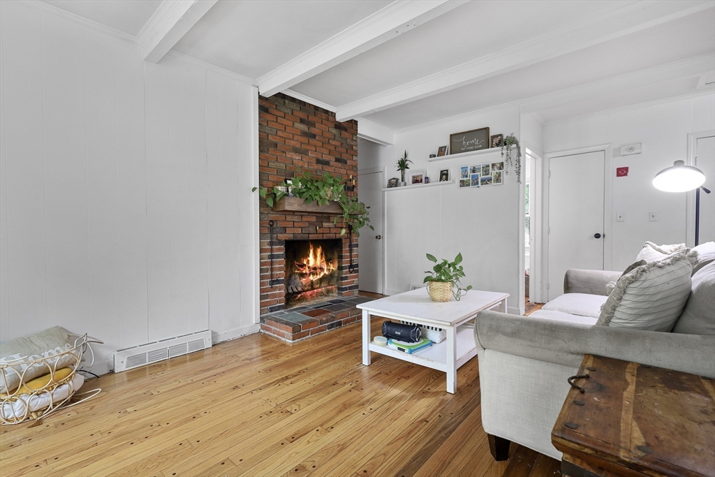 17 Pine Street Bellingham, MA 02019 - Photo 8 of 26 a living room with furniture and a fireplace
