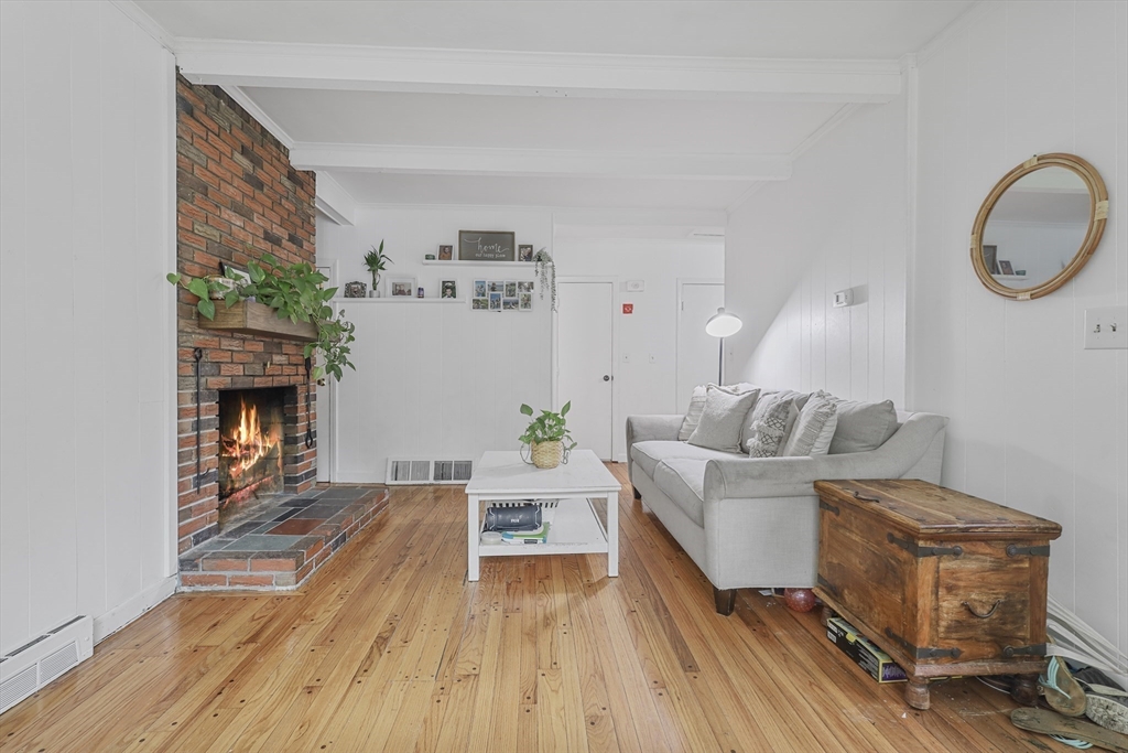 17 Pine Street Bellingham, MA 02019 - Photo 9 of 26 a living room with furniture and a fireplace