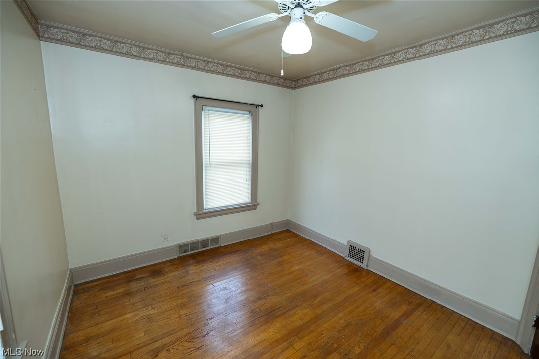 10105 Unity Avenue Cleveland, OH 44111 - Photo 8 of 35 Unfurnished room with ceiling fan and dark hardwood floors