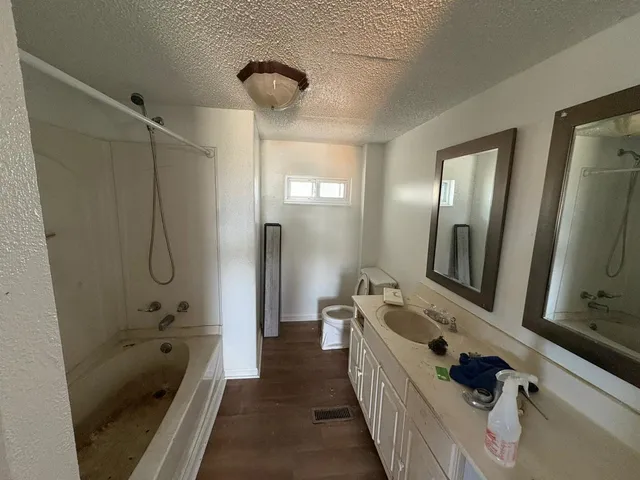 a bathroom with double vanity and a bathtub