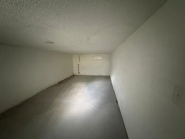a view of a room with wooden floor and window