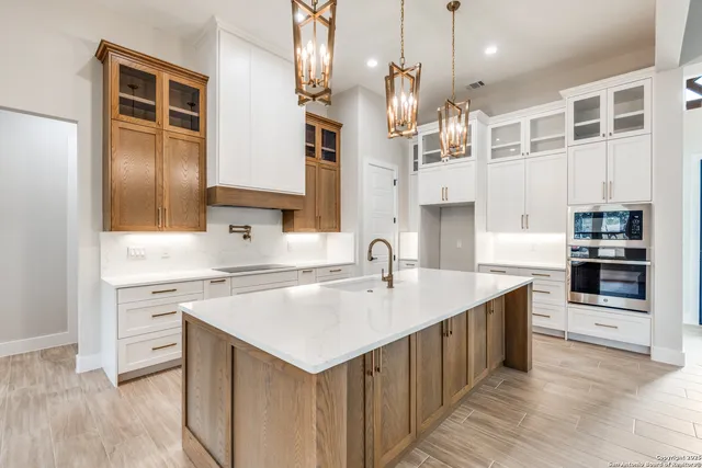a kitchen with a sink refrigerator and cabinets