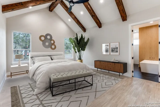 a bedroom with a large bed and a couch