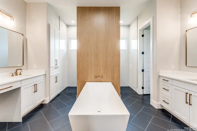 a bathroom with a tub sink and mirror