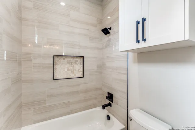 a bathroom with a bathtub and shower
