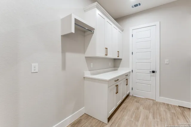 a kitchen with white cabinets and white appliances