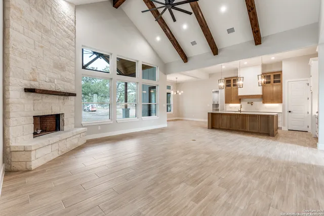 a large hall with kitchen and fireplace