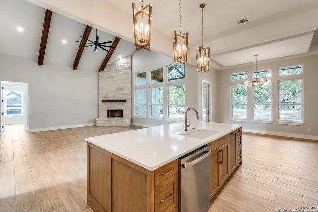 a kitchen with a stove and a wooden floor