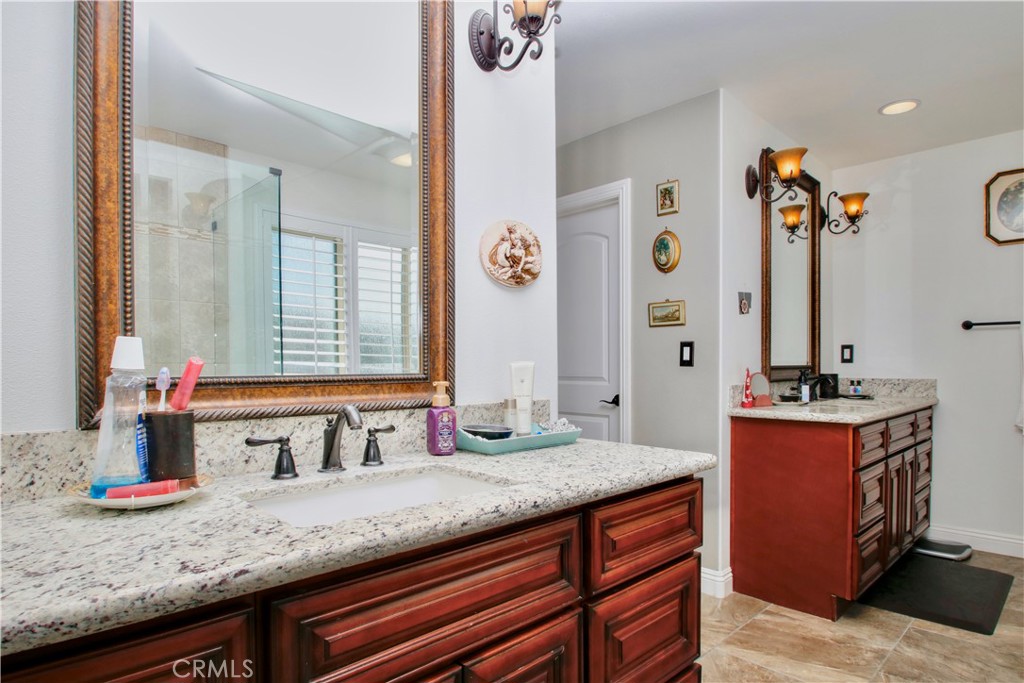6202 Mandarin Road Yucca Valley, CA 92284 - Photo 16 of 24 a bathroom with a granite countertop sink and a mirror