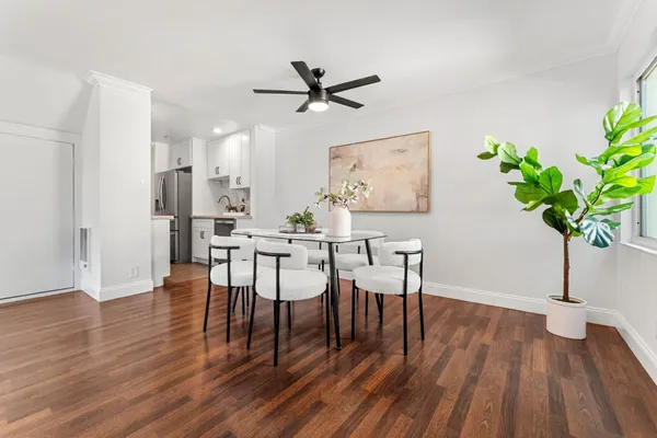 a view of a dining room with furniture and wooden floor