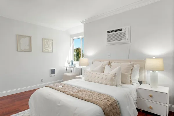 a bedroom with a bed and a night stand