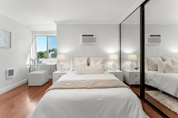 a bedroom with bed and a couch