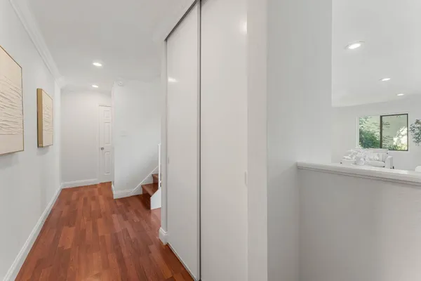 a view of hallway with wooden floor