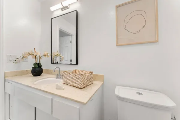 a bathroom with a toilet sink and mirror