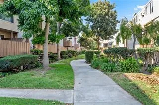 a front view of a house with a yard and trees