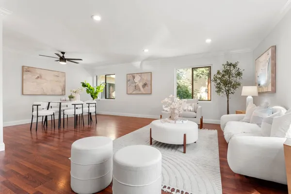 a living room with furniture and wooden floor
