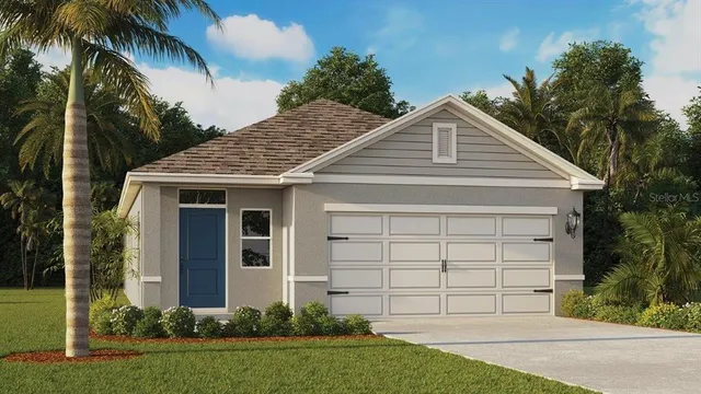 a view of a white house with a yard and potted plants
