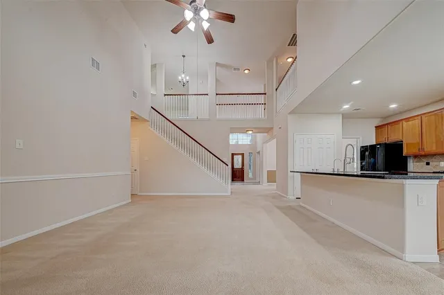a view of a kitchen with furniture and stainless steel appliances