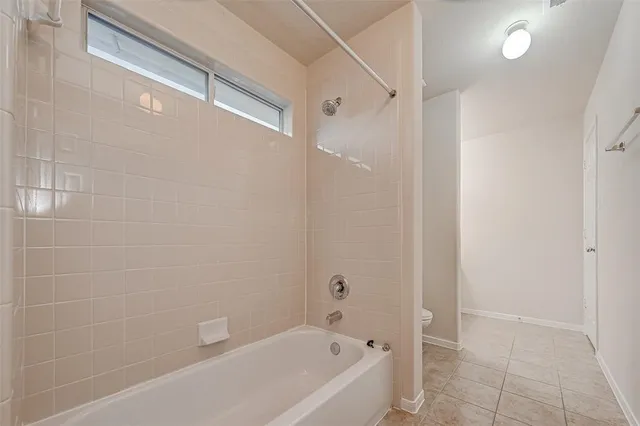 a bathroom with a bathtub and shower