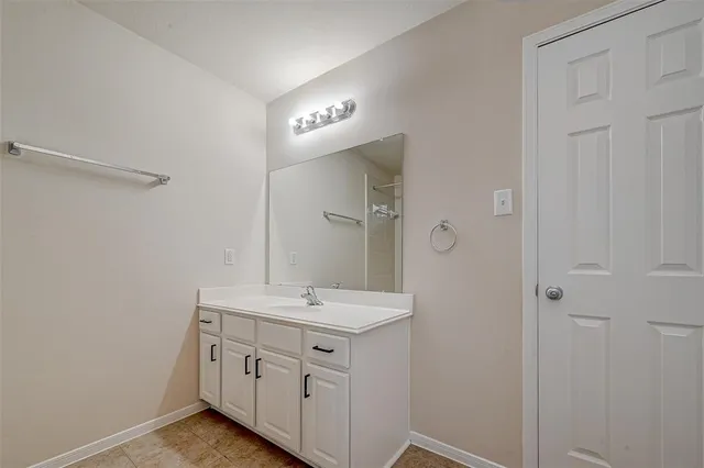 a bathroom with a double vanity sink a and mirror