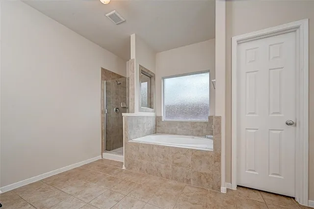 an empty room with cabinet and mirrors