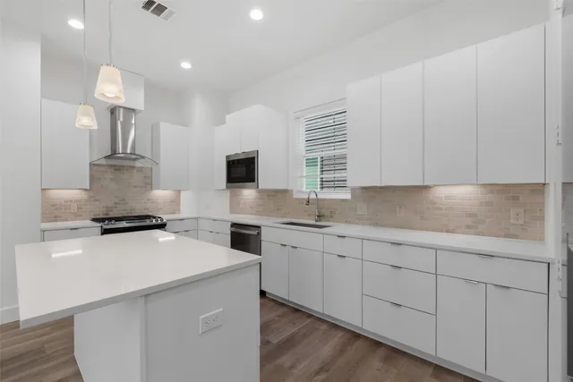 a kitchen with a sink stove and refrigerator