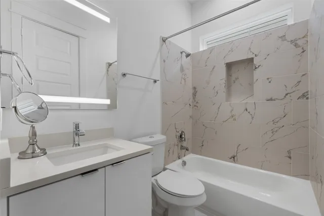 an empty room with a ceiling fan and a window